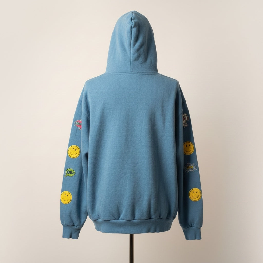 A Brand Called California blue heavy cotton unisex hoodie with all-over yellow smiley face patches and comic book style speech bubbles.