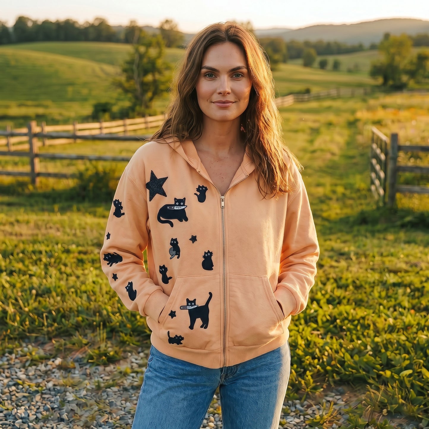 A Brand Called California cream cropped zip-up hoodie with black cat and star hand sewn embroidery design. Model wears jeans outdoor